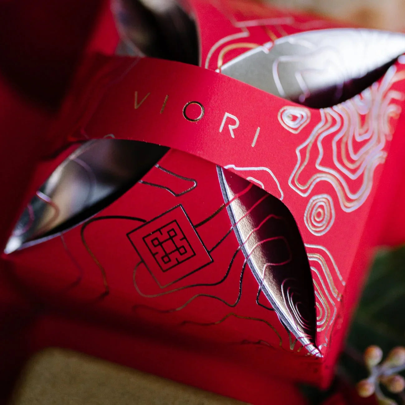 Red EPS bee hive with intricate gold and silver topographic design and cut-out details
