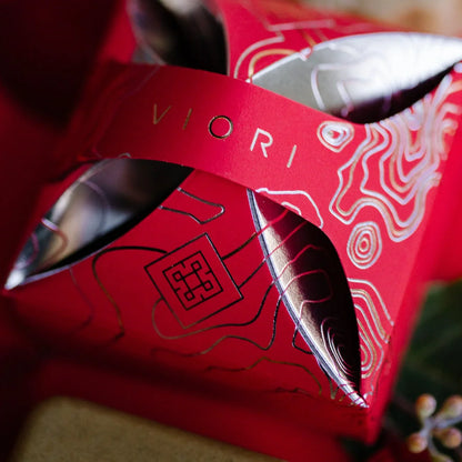 Red EPS bee hive with intricate gold and silver topographic design and cut-out details
