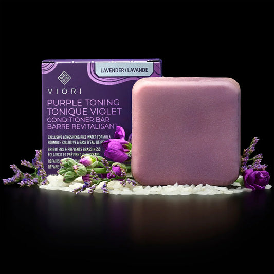 Viory purple toning lavender conditioner bar with rice grains and purple flowers on black background